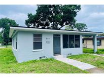 Cozy single-story home featuring a screened porch and simple, clean landscaping at 820 Maley St, Daytona Beach, FL 32114