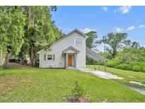 Charming home with an orange front door, neutral siding, and a covered carport at 1161 Dot Dr, Altamonte Springs, FL 32714