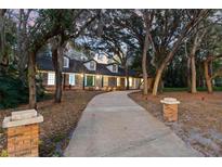 Charming one-story home featuring a brick exterior, dormer windows, and mature trees at 140 Sweet Bay Cir, Lake Mary, FL 32746