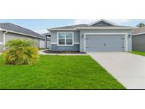 Charming single-Gathering home with a well-maintained lawn and a two-car garage at 141 Sandestin Dr, Haines City, FL 33844
