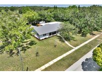 Charming single-story home with a metal roof and a well-maintained lawn at 1510 Live Oak St, New Smyrna Beach, FL 32168
