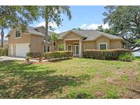Charming single-story home featuring lush front yard landscaping and a welcoming front entrance at 16729 Tall Grass Ln, Clermont, FL 34711