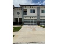 Modern townhome with a two-car garage and well-maintained landscaping at 2041 Greenbriar Ter, Davenport, FL 33837