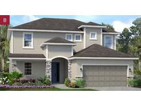 Charming two-story home with a two-car garage, stone accents, and a landscaped front yard at 2524 Raghav Trl, Tavares, FL 32778