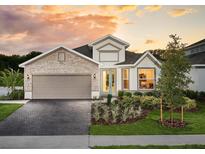 Charming single-story home featuring stone accents, a two-car garage, and lush landscaping at 2530 Raghav Trl, Tavares, FL 32778