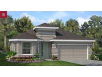 Charming single-story home featuring a two-car garage, neutral paint, and manicured landscaping at 2533 Raghav Trl, Tavares, FL 32778