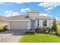 Charming single-Gathering home with a two-car garage, well-maintained lawn, and inviting curb appeal at 2533 Raghav Trl, Tavares, FL 32778