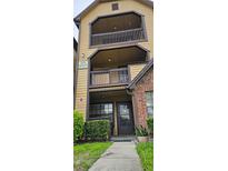 Inviting two-story condo featuring private balconies, brick accents, and well-maintained landscaping at 320 Forestway Cir # 107, Altamonte Springs, FL 32701