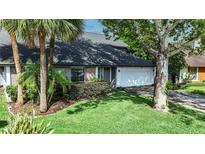 Charming home with a well-manicured lawn and mature trees, offering curb appeal at 359 Westwind Ct, Lake Mary, FL 32746