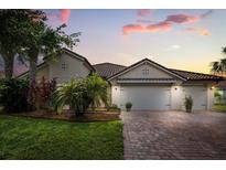 Charming single-story home with a brick driveway and a manicured lawn and garden at 3847 Shoreside Dr, Kissimmee, FL 34746
