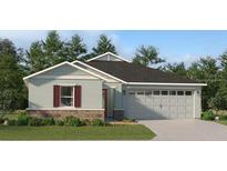 Charming single-story home with a two-car garage, a combination brick and siding facade, and manicured landscaping at 3958 Bigarade Ln, Lake Alfred, FL 33850