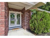 Inviting front entry features double glass doors and colorful flower arrangement at 5436 Tangerine Ave, Winter Park, FL 32792