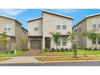 Charming two-story home featuring modern architecture, a two-car garage and front yard landscaping at 9239 Sommerset Hills Dr, Davenport, FL 33896