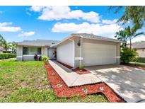 Charming single-story home featuring a well-manicured lawn and a two-car garage with ample parking at 963 Beach Breeze Dr, Orlando, FL 32835