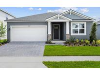 Charming one-story home featuring a two-car garage, covered entryway, and neatly landscaped front yard at 13232 Pergola Ave, Orlando, FL 32832