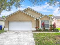 Charming single-story home with a two-car garage, landscaped front yard, and beautiful curb appeal at 2314 Cormorant St, Kissimmee, FL 34743