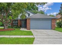 Charming single-Gathering home with a brick facade and mature landscaping in a well-maintained yard at 3107 Ash Park Loop, Winter Park, FL 32792