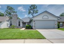 Charming single-story home with a well-maintained lawn, stone accents, and an attached two-car garage at 478 N Sundance Dr, Lake Mary, FL 32746