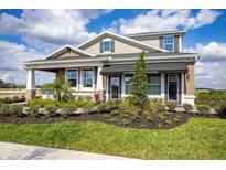 Charming home exterior featuring manicured landscaping, covered entry, and architectural details at 5328 Teirgarten St, St Cloud, FL 34771
