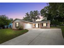 Charming single-story home featuring a well-manicured front yard and attached garage, perfect for suburban living at 5820 Indian Hill Rd, Orlando, FL 32808
