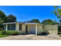 Charming single-story home features a convenient attached garage and well-maintained landscaping at 60 Palmetto Dr, Ormond Beach, FL 32176