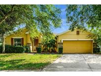 Charming single-story home with a well-manicured front lawn and a two-car garage at 969 Springs Landing Dr, Deltona, FL 32725