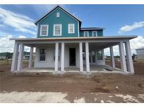 Charming two-story home with blue siding, white trim, and a covered front porch at 10224 Fiddley Aly, Orlando, FL 32827