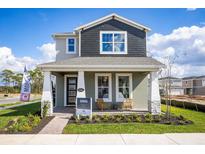 Charming two-story home with a covered front porch and well-maintained landscaping at 1341 Lumpini St, St Cloud, FL 34771