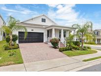 Charming single-Gathering home with a two-car garage, covered front porch, and beautifully landscaped front yard at 1382 Foltz Loop, Oakland, FL 34787