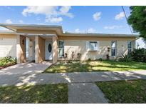 Inviting exterior of a home with a well-maintained lawn and a walkway leading to the front door at 1543 Club Cir, Lakeshore, FL 33854