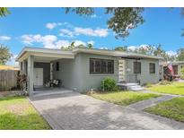 Charming one-story home featuring a brick driveway, covered parking and freshly painted exterior at 2603 E Marks St, Orlando, FL 32803