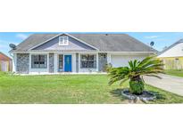 Charming single-Gathering home with stone accents, well-maintained lawn, and blue front door at 3038 Golden Rock Dr, Orlando, FL 32818