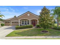 Charming single-story home featuring a well-manicured lawn and inviting front porch at 3551 Statham Dr, Apopka, FL 32712