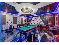 Extravagant game room featuring a Star Wars theme, pool table, and arcade games at 4161 Paragraph Dr, Kissimmee, FL 34746