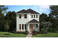 Charming two-story home with a well-maintained lawn and landscaping at 446 Scotsmans Pl, Debary, FL 32713