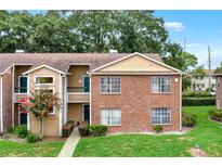 Inviting brick and siding townhouse with lush landscaping and charming curb appeal in a desirable neighborhood at 5545 Devonbriar Way # 206, Orlando, FL 32822