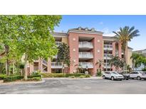 Attractive condominium complex featuring a colorful facade and well-maintained landscaping at 7650 Whisper Way # 104, Reunion, FL 34747