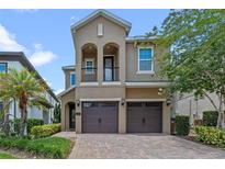 Charming two-story home with a two-car garage and well-maintained landscaping and a beautiful paver driveway at 796 Desert Mountain Ct, Reunion, FL 34747