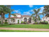 Stunning single-Gathering home with a clay tile roof, lush landscaping, and inviting curb appeal at 8531 Cypress Hollow Ct, Sanford, FL 32771