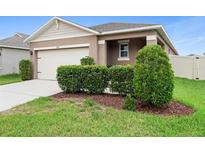 Charming single-Gathering home with well-maintained landscaping and a two-car garage at 927 Denali Dr, Orange City, FL 32763