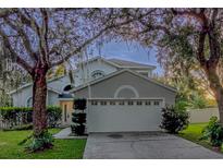 Charming two-story home featuring a two-car garage and mature landscaping at 13200 Mallard Cove Blvd, Orlando, FL 32837