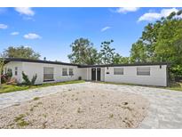Charming single-story home featuring a neatly paved driveway and lush landscaping at 1511 E Horatio Ave, Maitland, FL 32751