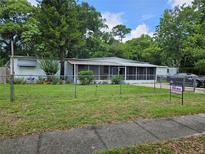 Charming single-story home with a fenced front yard and a screened-in porch, offering both curb appeal and outdoor living at 1525 Hilltop Rd, Casselberry, FL 32707