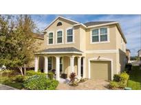 Charming two-story home with manicured landscaping and welcoming front porch at 1625 Nassau Point Trl, Kissimmee, FL 34747