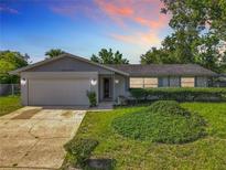 Charming single-story home with well-maintained landscaping and a two-car garage at 217 Melissa Ct, Sanford, FL 32773