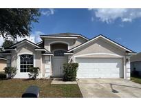 Charming single-Gathering home with a two-car garage and well-maintained lawn at 307 Dalton Ct, Davenport, FL 33897