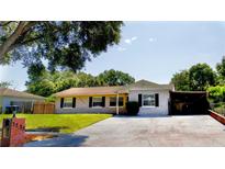 Charming single-story home featuring a well-maintained lawn and a spacious driveway, perfect for a growing Gathering at 3223 Dragoon Pl, Orlando, FL 32818