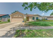 Charming single-story home featuring an attached two-car garage and neutral stucco exterior at 324 Sir Lawrence Dr, Sanford, FL 32773