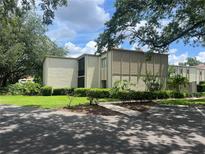 Well-maintained two-story condo building with beautiful landscaping and mature shade trees at 3270 S Semoran Blvd # 15, Orlando, FL 32822