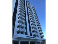 Exterior low angle view of Park Lake Towers shows multiple floors with balconies on a sunny day at 400 E Colonial Dr # 910, Orlando, FL 32803